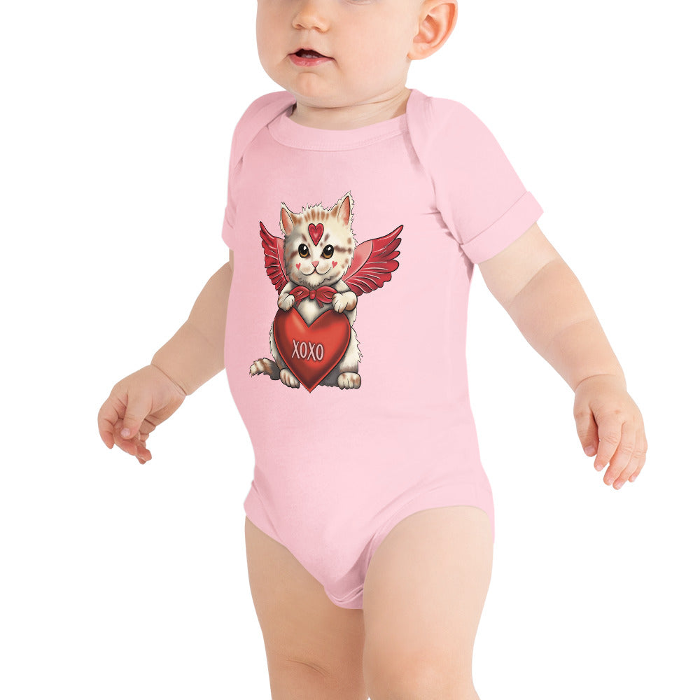 Pictured is a baby girl wearing a pink one piece bodysuit with short sleeves and 3 snaps. The adorable design on this baby clothing is       to be worn for Valentine's Day. The cute graphic design is a cute kitten dressed up as Cupid and holding a red heart that says "xoxo".       This unique snapsuit infant clothing comes in 4 colors, pink, grey, yellow, and white. Sizes available are 3-6 months, 6-12 months, and      12-18 months.