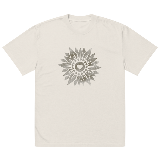 The front view of a t-shirt design on a light colored boxy fit tee. There is a vintage looking sunflower graphic printed on the front. 